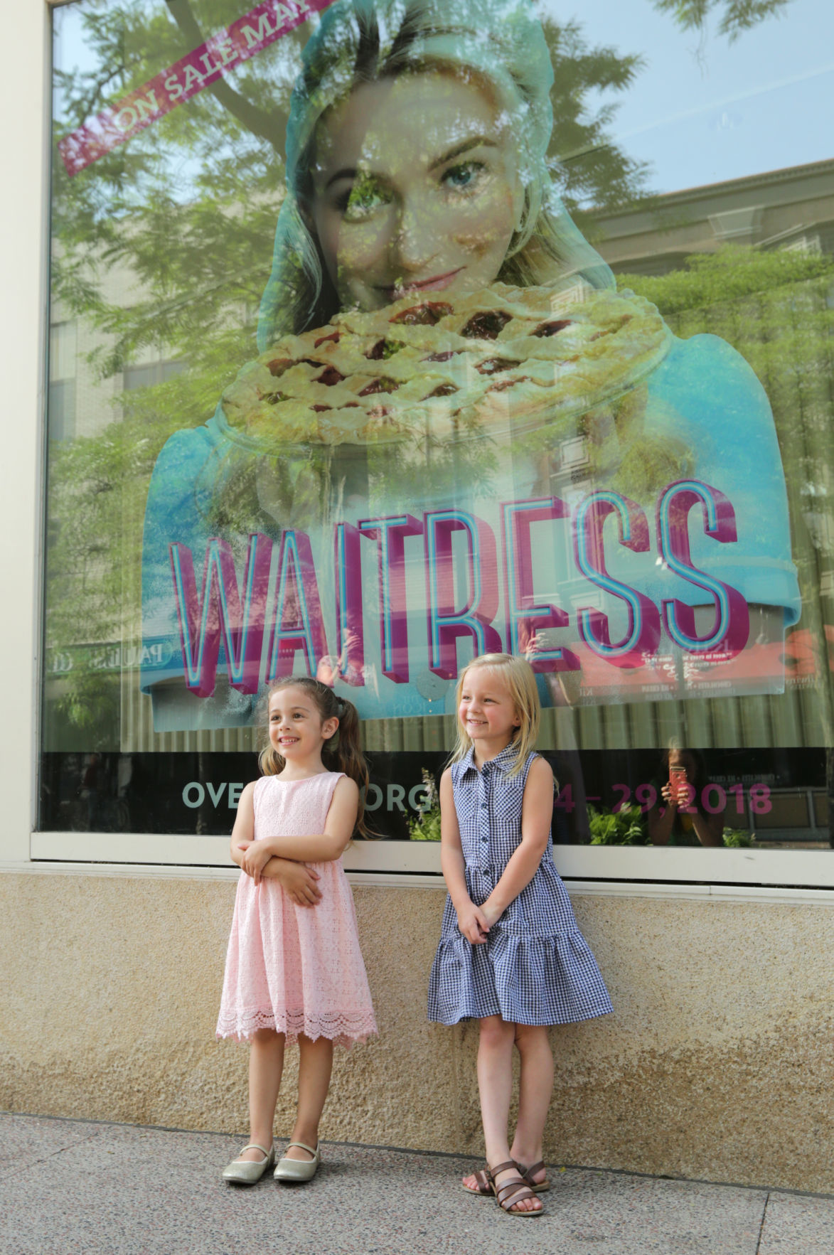 Addie Manthey and Rosie Manson outside Overture window